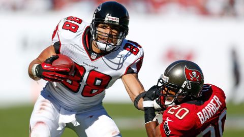 Tight end Tony Gonzalez of the Falcons straight arms safety Ronde Barber of the Buccaneers on Sunday.