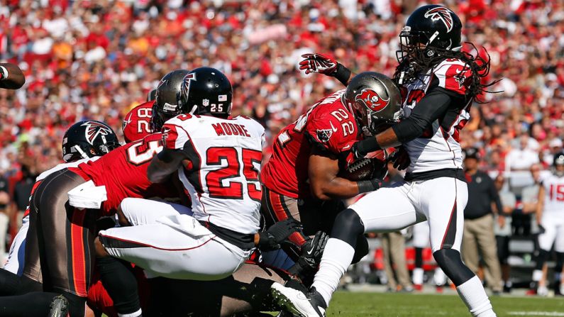 Running back Doug Martin of the Buccaneers is tackled by defender Dunta Robinson of the Falcons on Sunday.