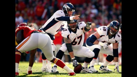 Quarterback Peyton Manning of the Broncos surveys the defense with center Dan Koppen during the game against the Chiefs on Sunday.
