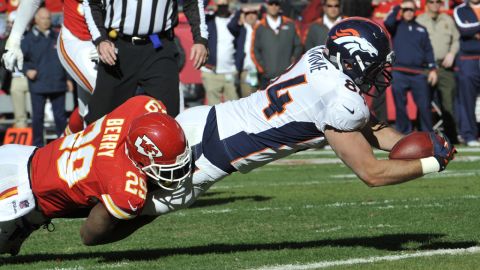 Tight end Jacob Tamme of the Broncos dives across the line for a touchdown against Eric Berry of the Chiefs during the first half on Sunday.