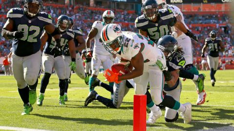 Reggie Bush of the Miami Dolphins rushes for a touchdown against the Seattle Seahawks at Sun Life Stadium on Sunday.