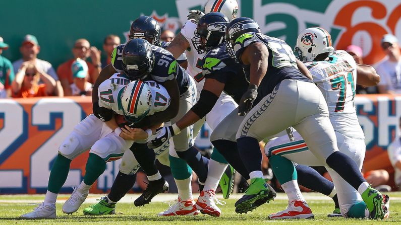Ryan Tannehill of the Dolphins is sacked by Chris Clemons of the Seahawks on Sunday.