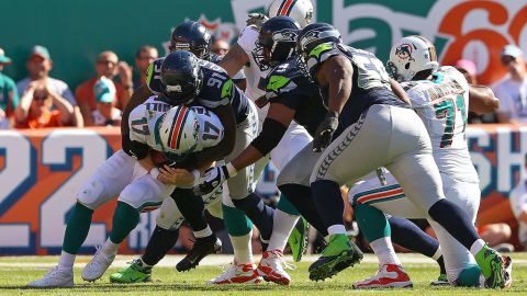 Ryan Tannehill of the Dolphins is sacked by Chris Clemons of the Seahawks on Sunday.