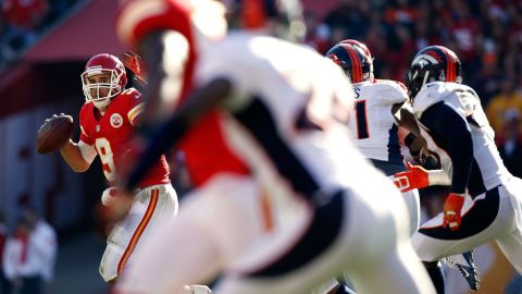 Quarterback Brady Quinn of the Chiefs scrambles against the Broncos on Sunday.