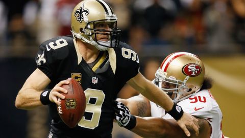 Drew Brees of the Saints is pressued by Isaac Sopoaga of the 49ers on Sunday.
