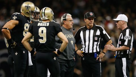Interim head coach Joe Vitt of the Saints talks with referee John Parry during a timeout against the 49ers on Sunday.