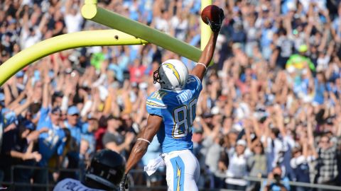 Wide receiver Malcom Floyd of the Chargers dunks the ball in the field goal uprights after scoring a touchdown against Ravens on Sunday.