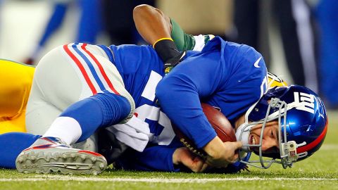 Tramon Williams of the Packers tackles Giants quarterback Eli Manning in the open field at MetLife Stadium on Sunday.