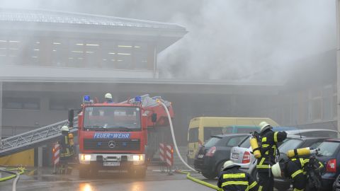Firefighters stand in front of house with a workshop for handicapped people in Titisee- Neustadt on November 26, 2012. 