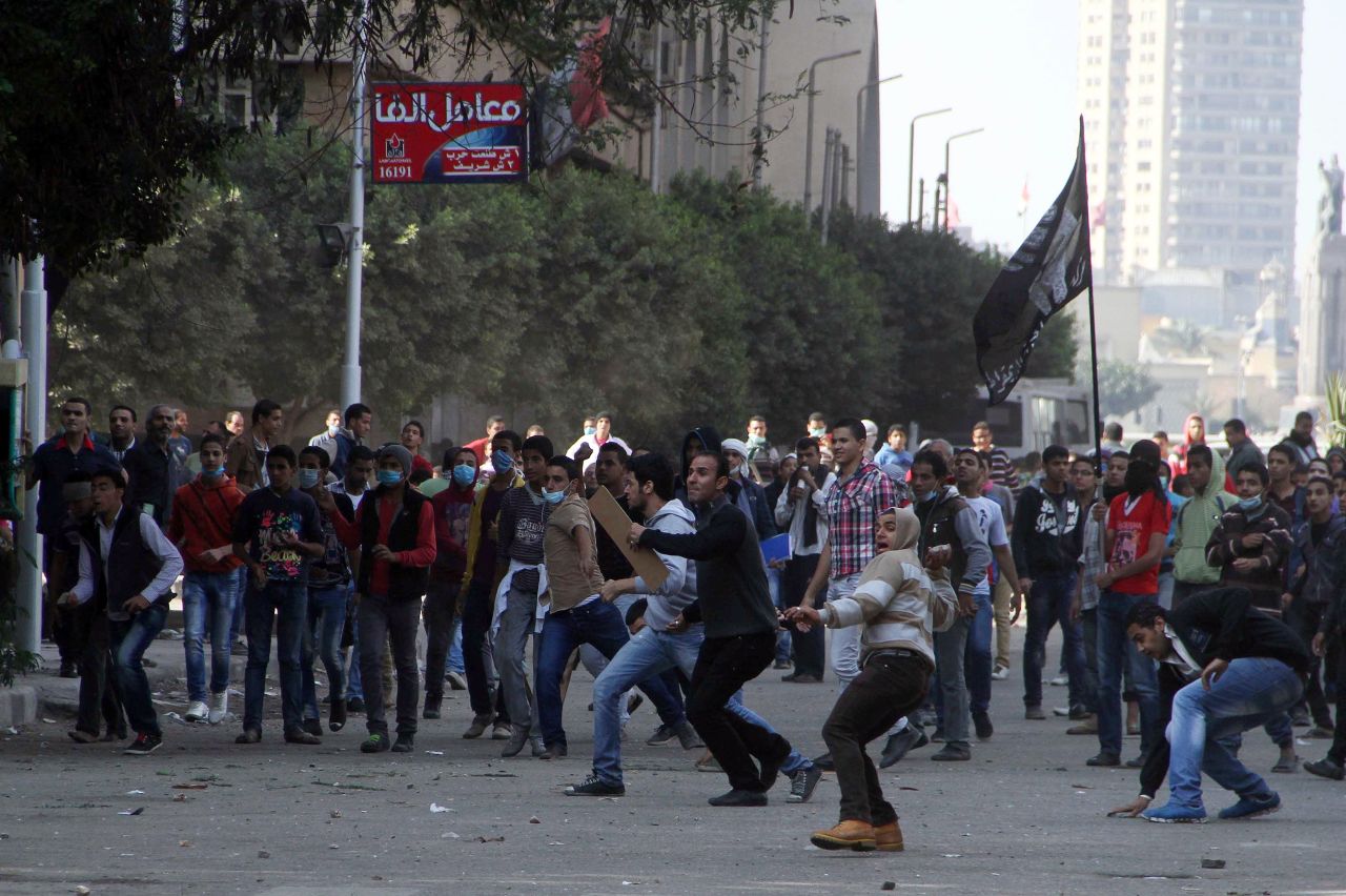 Egyptian protesters hurl stones at police at Tahrir Square on Sunday.