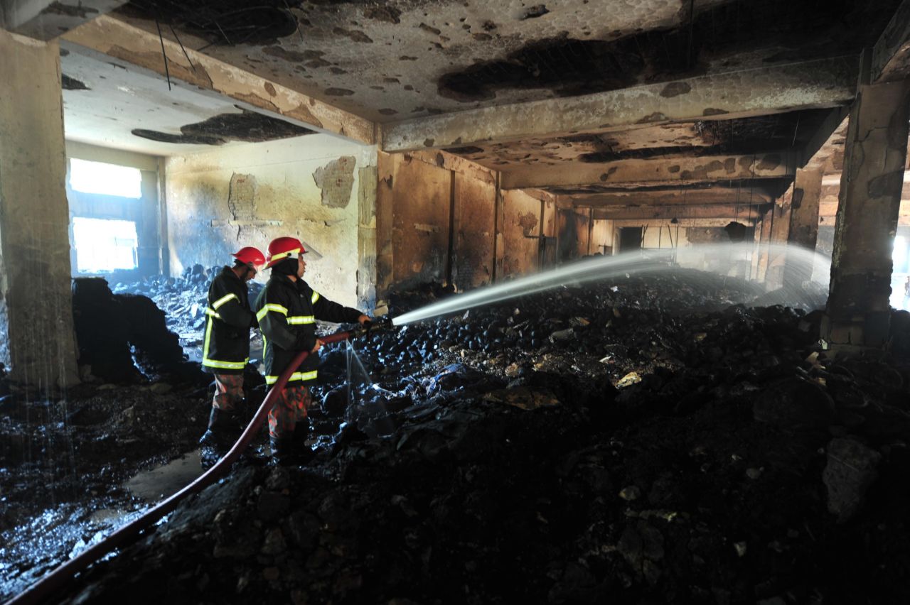 Firefighters douse hot spots on November 25.
