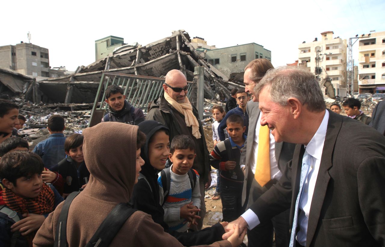 Robert Serry, the United Nations Special Coordinator for the Middle East Peace Process, greets children during a visit to Gaza to survey damage caused by the exchange of fire between Israel and Hamas militants, on Sunday, November 25.
