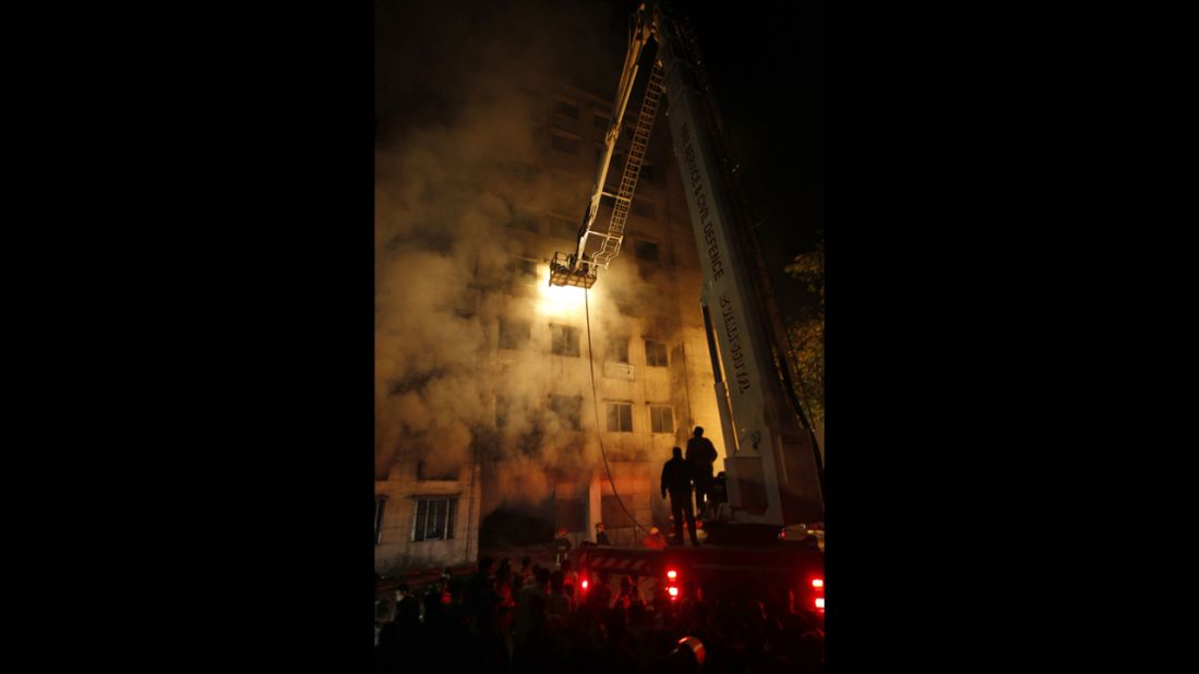 Firefighters work at the nine-story plant on November 25.