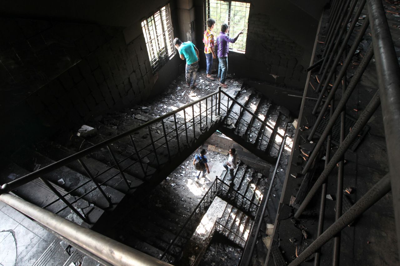 Bangladeshi garment workers check out the burned stairs of the plant on November 26.