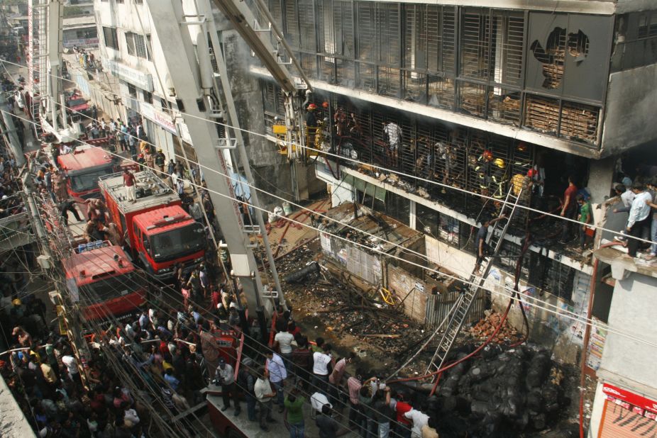 Bangladeshi firefighters stand in the burned-out building on November 26.