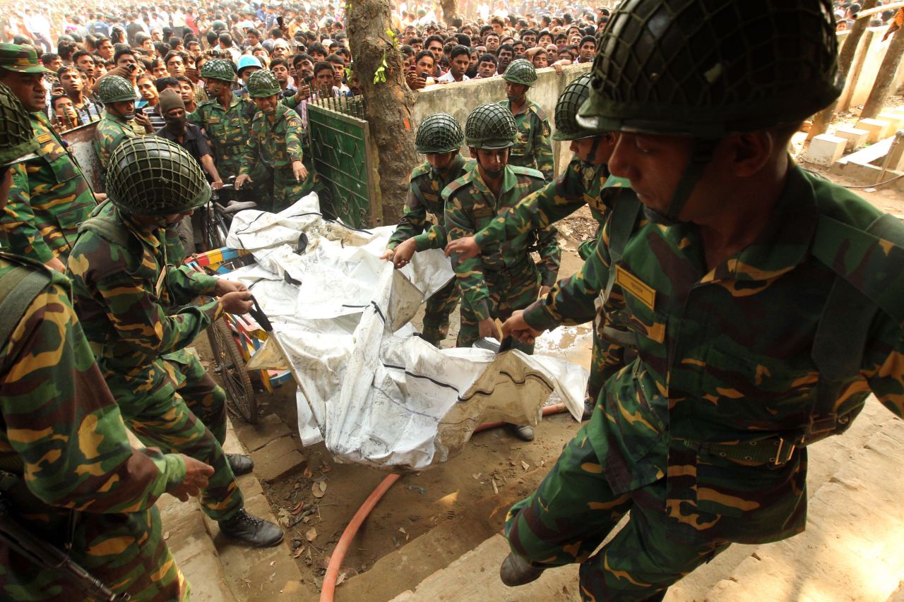 Bangladeshi army personnel transport the bodies of victims on November 25.