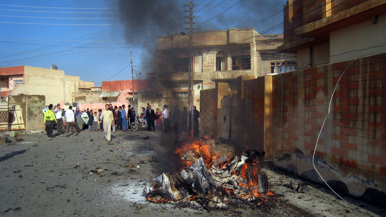 The remains of one of three car bombs burns in the northern Iraqi city of Kirkuk on Tuesday.