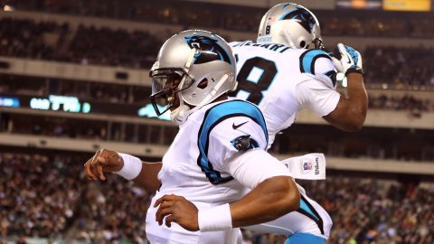 Panthers quarterback Cam Newton, left, celebrates a first quarter touchown with teammate Jonathan Stewart.