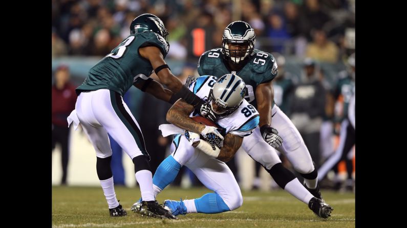 Panthers wide receiver Steve Smith  catches the ball between defenders Dominique Rodgers-Cromartie, left, and DeMeco Ryans of the Philadelphia Eagles.