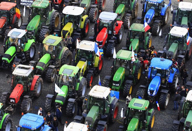 Farmers stand among hundreds of tractors during the demonstration on Monday.