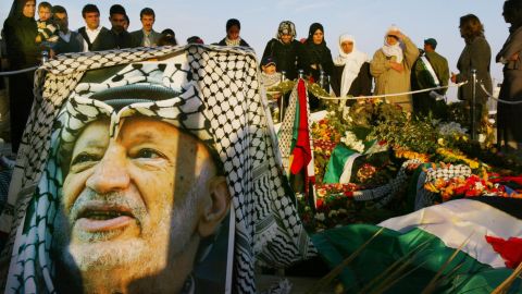 People visit the grave of Palestinian leader Yasser Arafat the day after he was buried in Ramallah, West Bank, in 2004.