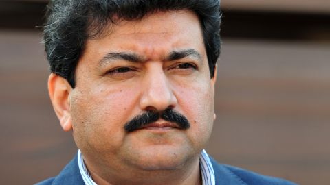 Pakistani journalist Hamid Mir talks with media outside his home in Islamabad on November 26, 2012.