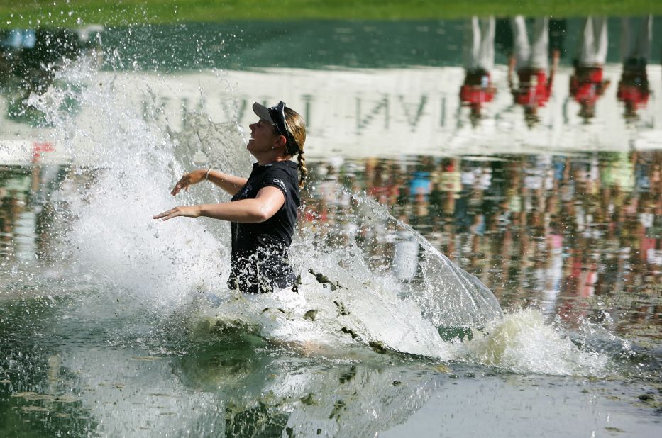 Sorenstam celebrates one of her 10 major titles by taking the traditional winner's leap into the lake after claiming the 2005 Kraft Nabisco Championship.
