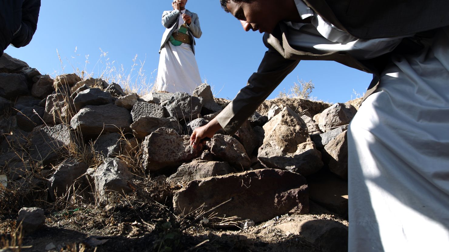 Yemeni men inspect the site where a Saudi diplomat and his bodyguard were killed, in Sanaa on November 28. 