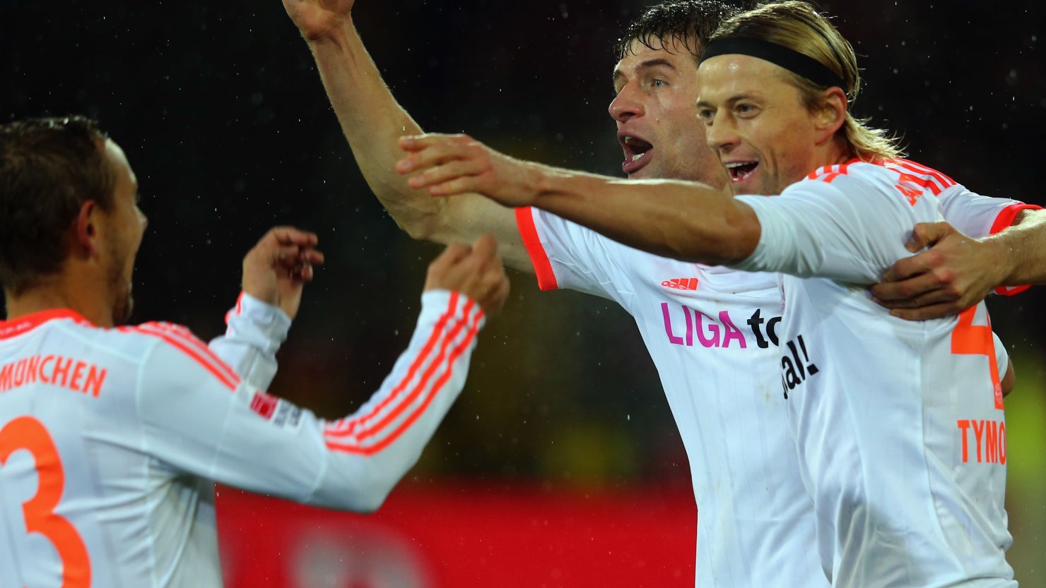 Anatoliy Tymoshchuk celebrates his goal in Bayern Munich's victory at Freiburg with teammates Thomas Mueller and  Rafinha.
