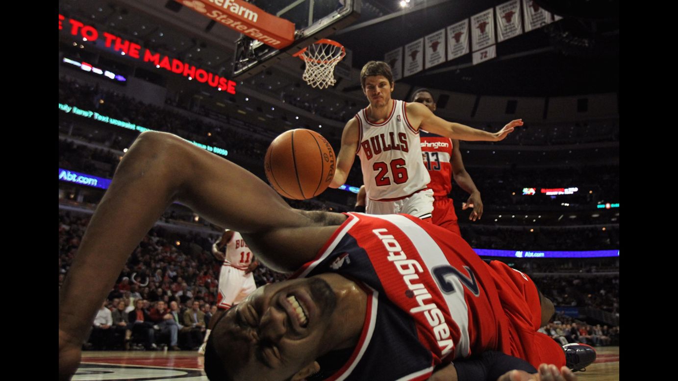 John Wall of the Washington Wizards hits the floor after taking a shot against Kyle Korver of the Chicago Bulls at the United Center on January 11 in Chicago.