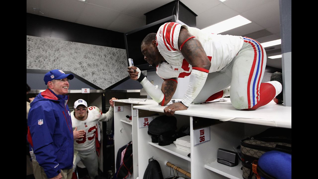 Derrick Martin of the New York Giants makes a video of head coach Tom Coughlin while they celebrate in the locker room after defeating the San Francisco 49ers 20-17 in the NFC Championship Game at Candlestick Park on January 22 in San Francisco.