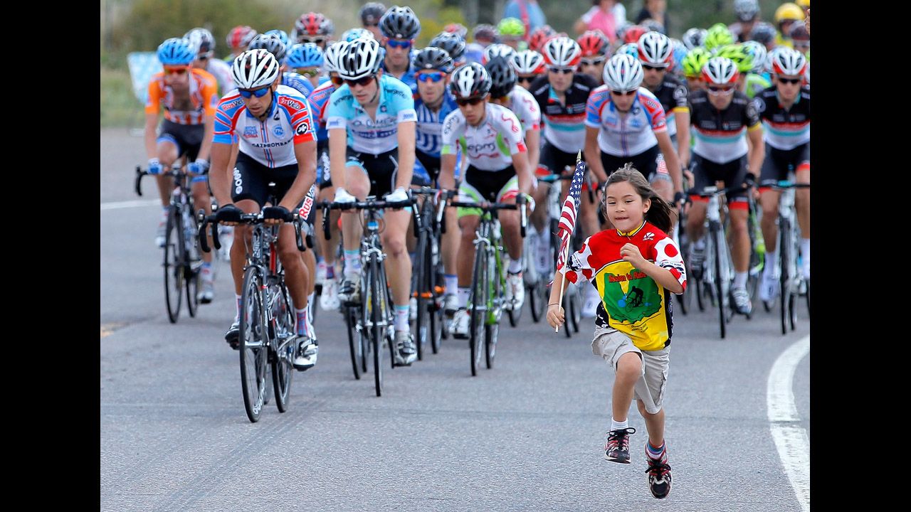 A young fan runs in front of the peloton during stage two of the USA Pro Challenge on August 21 in Sapinero, Colorado.