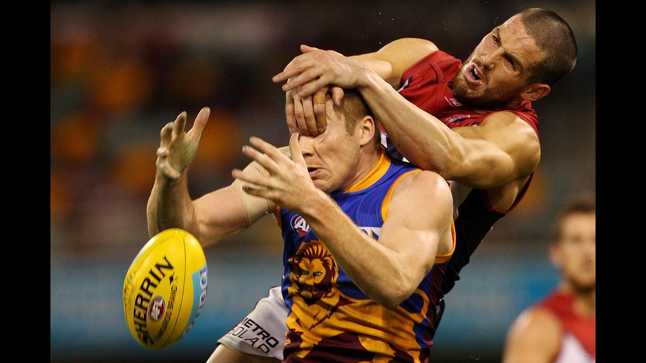 Ryan Harwood of the Brisbane Lions and James Magner of the Melbourne Demons compete for a mark during an Australian Football League match on July 1 in Brisbane, Australia.