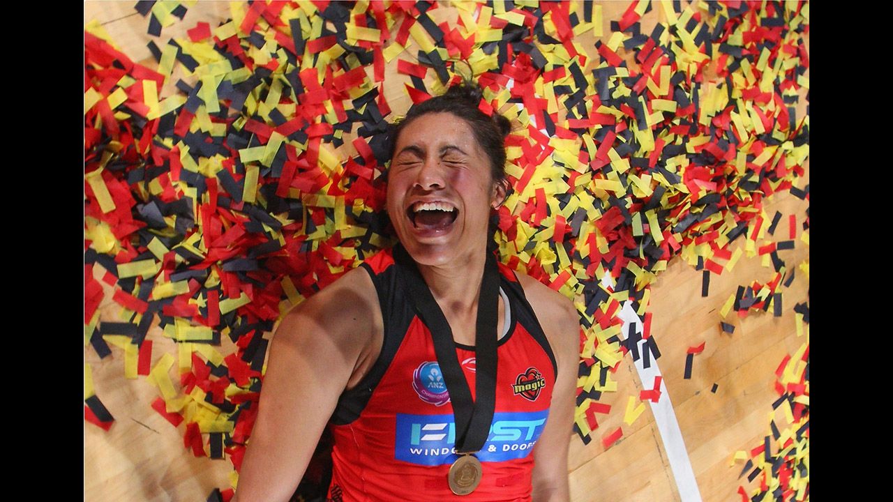 Julianna Naoupu of the Waikato Bay of Plenty Magic lies amongst the confetti after winning the Australian and New Zealand Netball League Championship match against the Melbourne Vixens on July 22 in Melbourne, Australia.