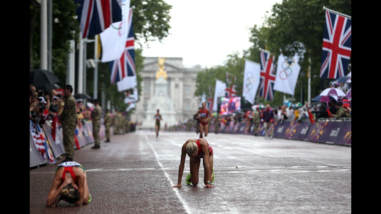 Athletes rest at the finish line of the women's marathon on Day 9 of the London 2012 Olympics on August 5.