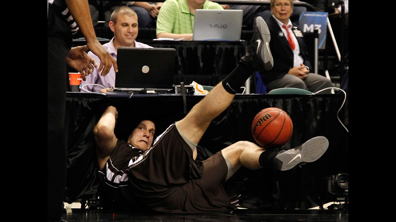 Justin Maneri of the Lehigh Mountain Hawks dives into the scorer's table after attempting to save the ball in the first half against the Duke Blue Devils during the second round of the 2012 NCAA Men's Basketball Tournament at Greensboro Coliseum on March 16.