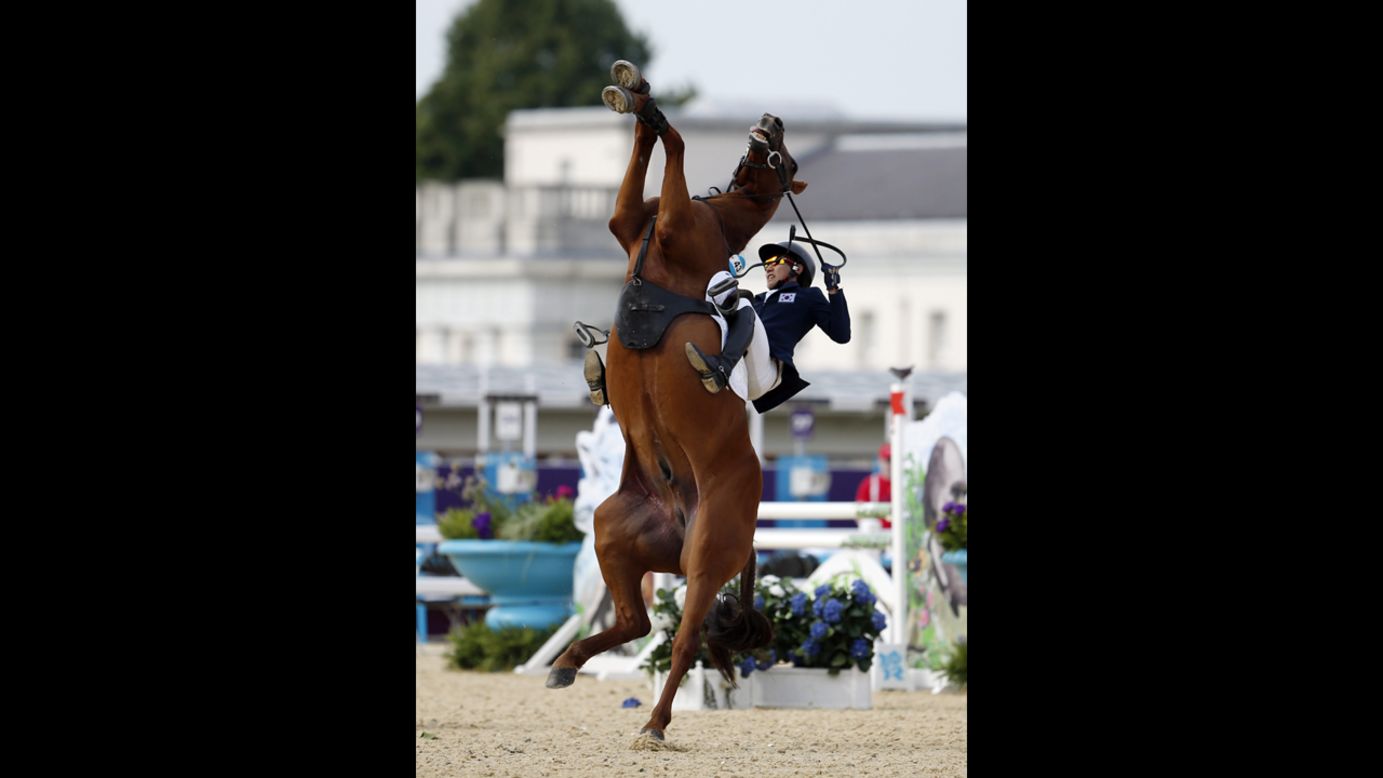 South Korea's Woojin Hwang is thrown from his horse Oscar Shearwater during the London 2012 Olympic Games men's modern pentathlon riding show jumping event at Greenwich Park on August 11. 