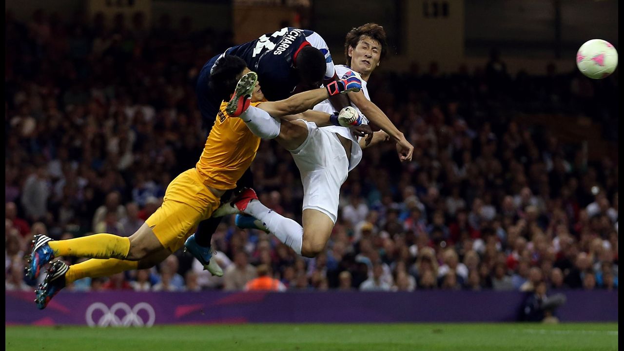 Great Britain's Micah Richards, top left, goes for the ball against South Korea's Jung Sung-ryong and Ji Dong-won in the men's football quarterfinal match on Day 8 of the London 2012 Olympic Games on August 4 in Cardiff, Wales.