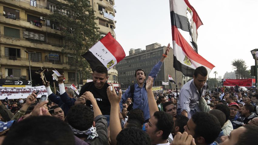 Egyptian protesters shout political slogans against President Mohammed Morsi's decree during a demonstration in Tahrir Square on November 27, 2012 in Cairo. Clashes between police and protesting youths erupted near Cairo's Tahrir Square, ahead of a mass rally against a decree by President Mohamed Morsi granting himself broad powers. The planned demonstrations come a day after Morsi stuck by his controversial decree in a meeting with judges that was aimed at defusing the worst political crisis since his election in June.