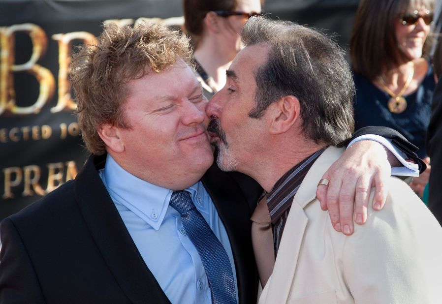 Actor Stephen Hunter, left, receives a kiss from actor William Kircher on the red carpet of the world premiere.