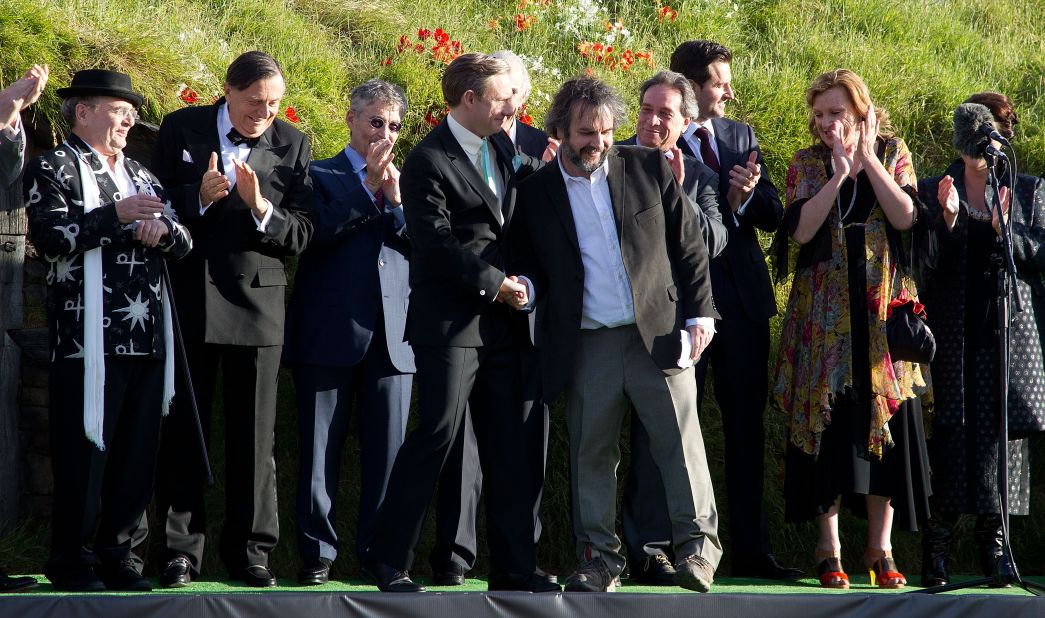 Actor Martin Freeman, left, is greeted by director Peter Jackson on stage with other cast members at the world premiere.