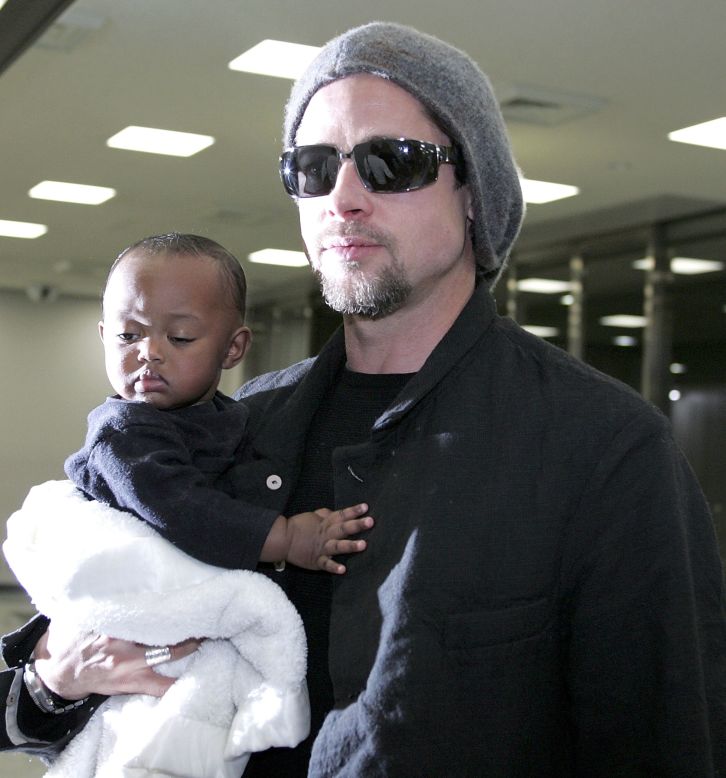 After his split from Aniston, it wasn't long before Pitt was seen spending time with Jolie's two adopted children, Maddox and Zahara, whom Pitt carries here through the New Tokyo International Airport in November 2005.