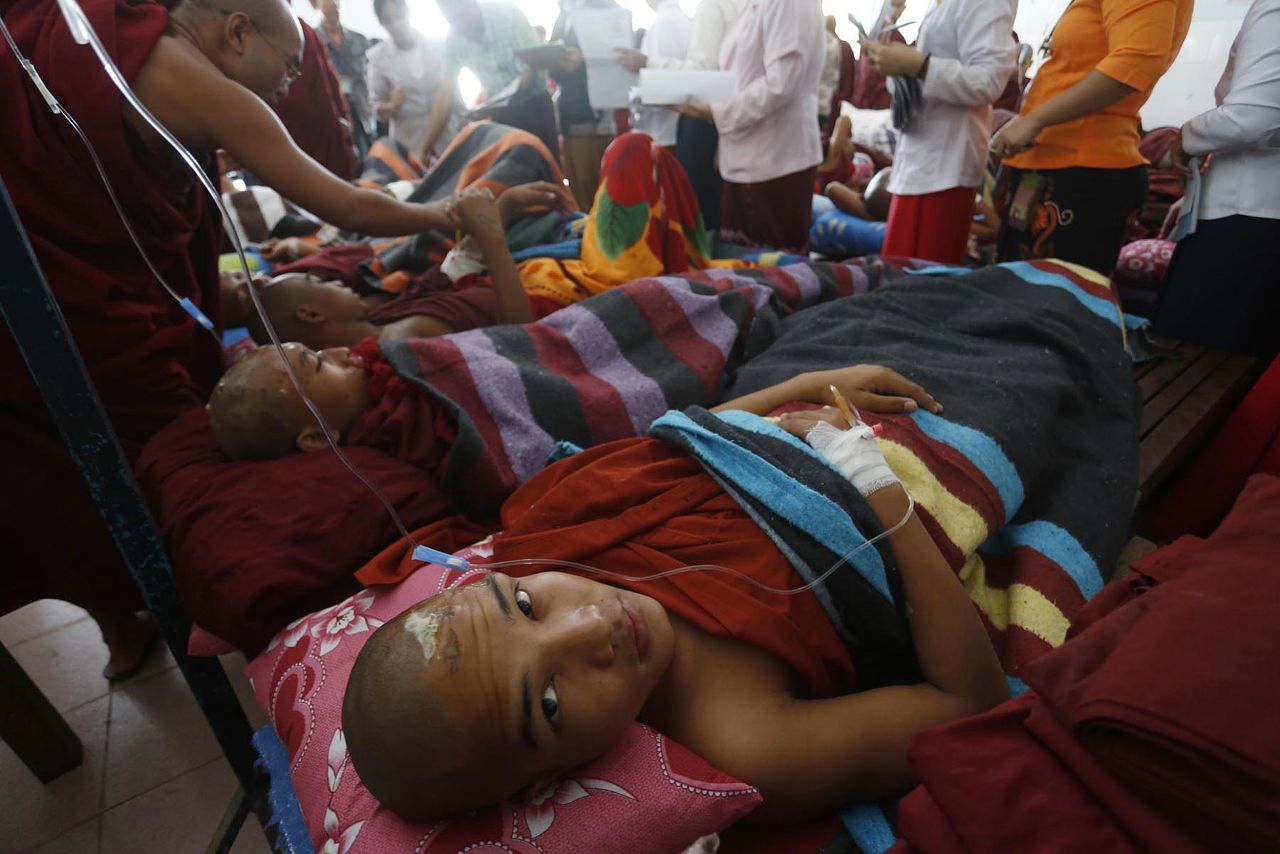 Monks receive treatment after a clash with police in northern Myanmar on November 29.