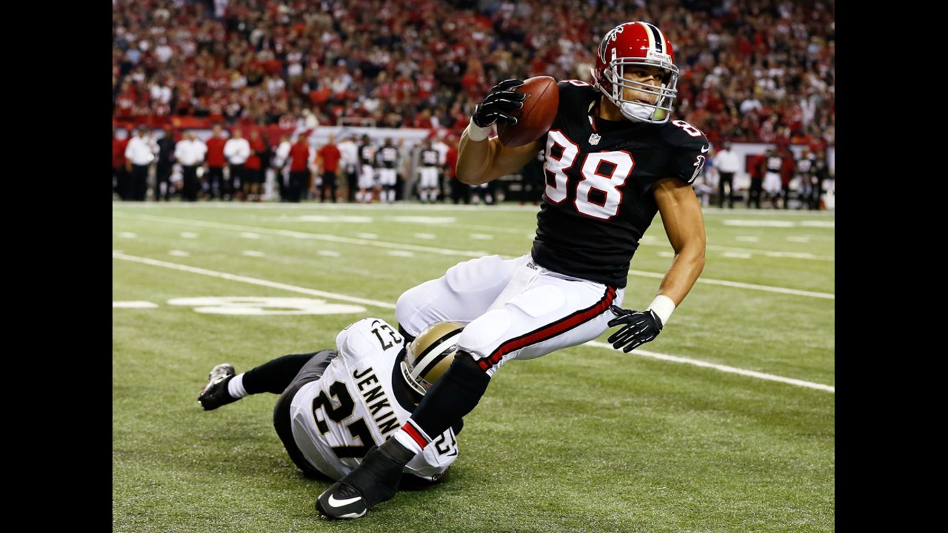 Tony Gonzalez of the Atlanta Falcons is tackled by Malcolm Jenkins of the New Orleans Saints on Thursday.