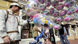 Picture taken on April 15, 2011 shows a balloon seller at the Tokyo Disneyland greeting visitors at Urayasu city, suburban Tokyo.
