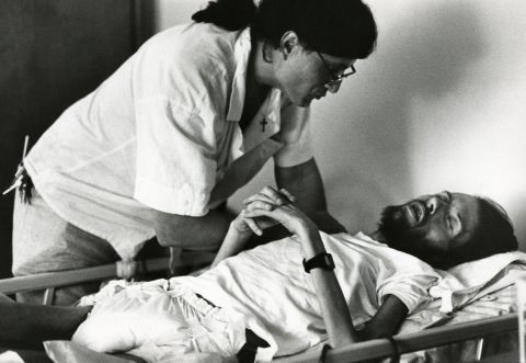 Peta, a volunteer at Pater Noster House, cares for Kirby. After Kirby's death in April 1990, Frare began photographing Peta, another AIDS patient.