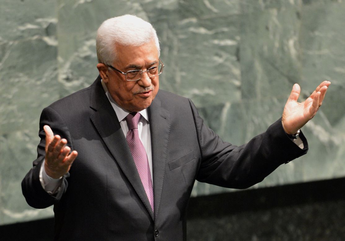 Mahmoud Abbas gestures to members at the General Assembly after speaking.