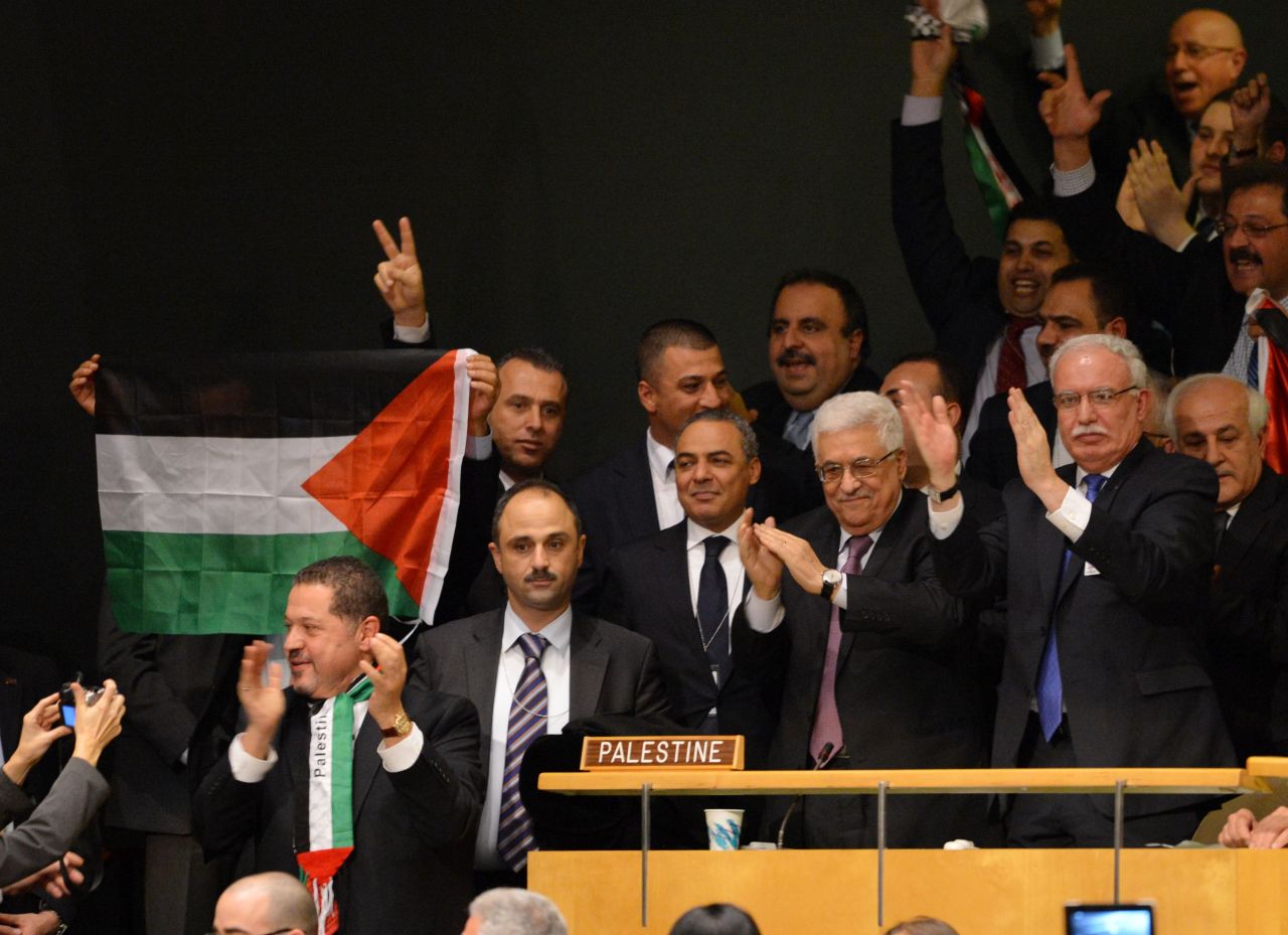 Mahmoud Abbas and the Palestinian delegates celebrate after the General Assembly votes to approve the resolution.