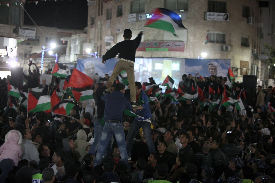 Palestinians celebrate in the West Bank city of Ramallah after hearing news of the successfully passed resolution at the General Assembly.