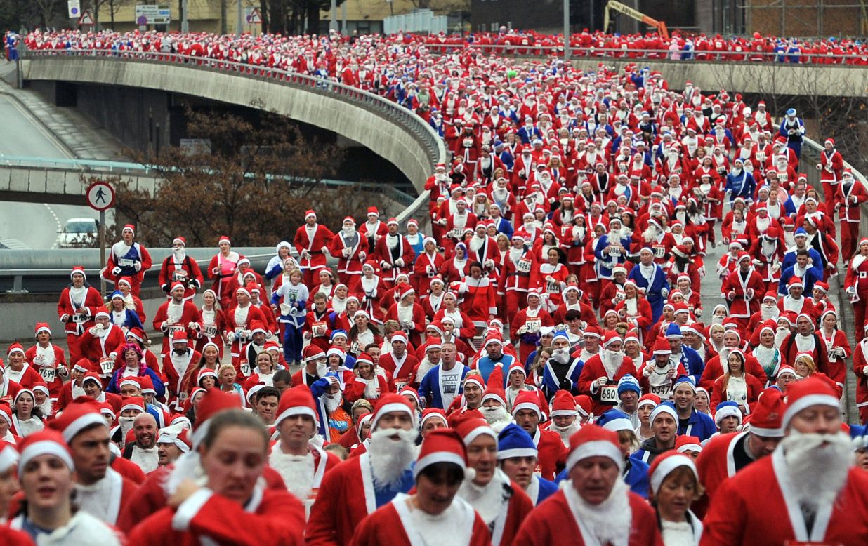 Runners dressed in Father Christmas costumes take part in the annual 5-kilometer Santa Dash in Liverpool, England, on Sunday, December 2. Many runners who refuse to run in red, the color of their football rivals Liverpool FC, wear blue to support the football team Everton FC.<br /><br />